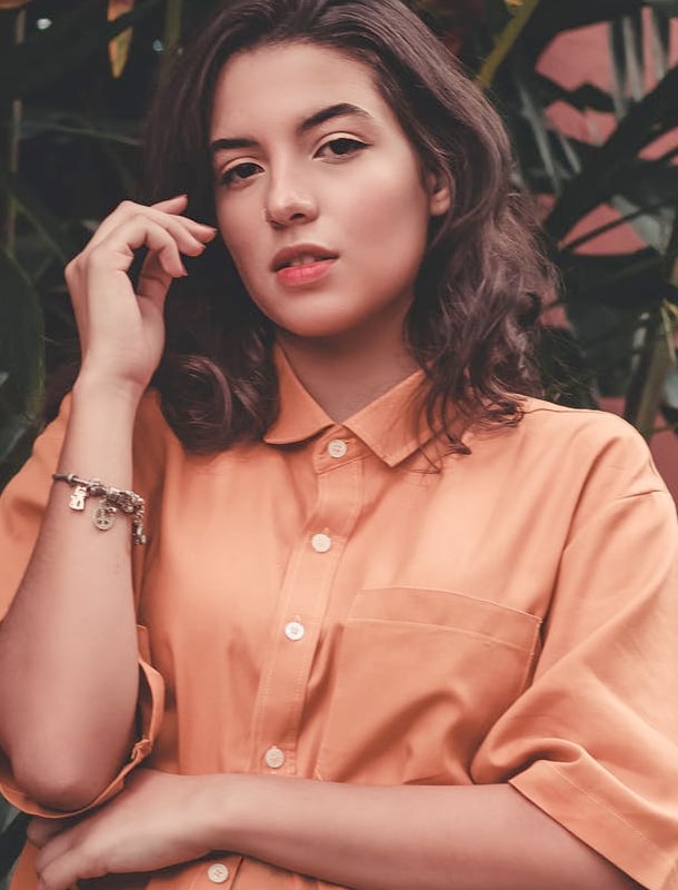 Woman in salmon shirt looking at the camera